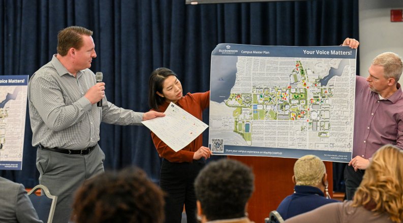 Group of people looks at a map of ODU campus