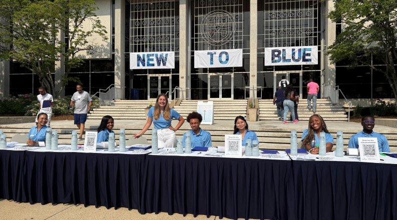 students at long desk in front of Webb Center