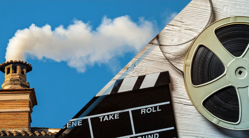 A chimney with white smoke and an image of a movie film reel.