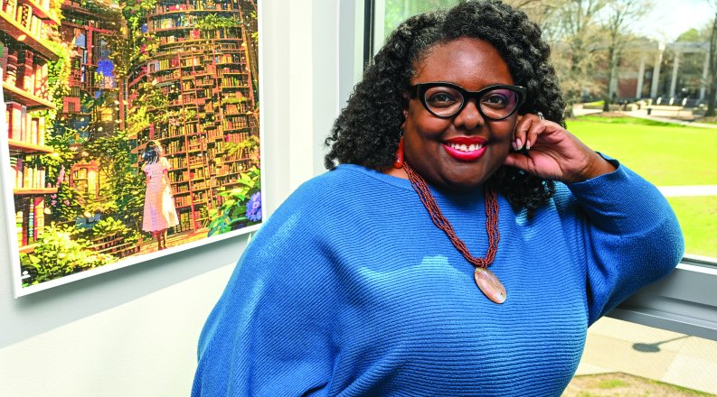Remica Bingham-Risher stands next a window in her office 