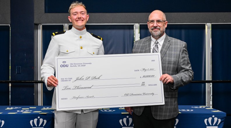 John Paul Peck and Dr. Brian Payne with a giant check