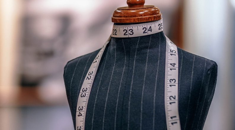 Fashion mannequin with measuring tape around neck 