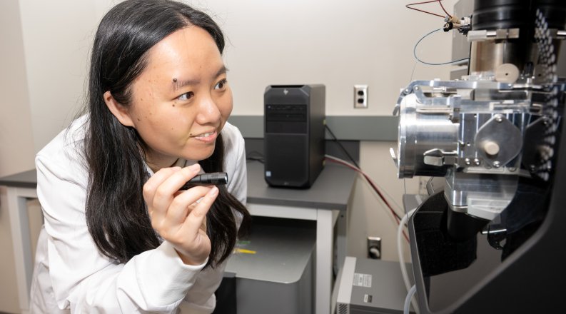 A photo of Yuting Zhu holding a flashlight.