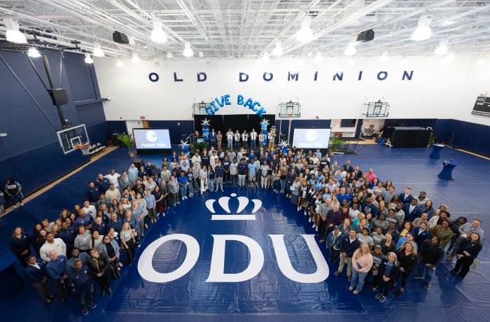 A group of people gathered in a gym.