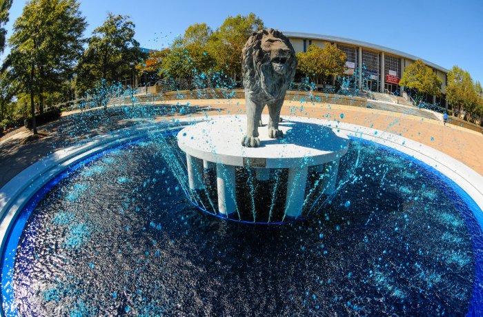 Lion statue in the middle of a waterfall 