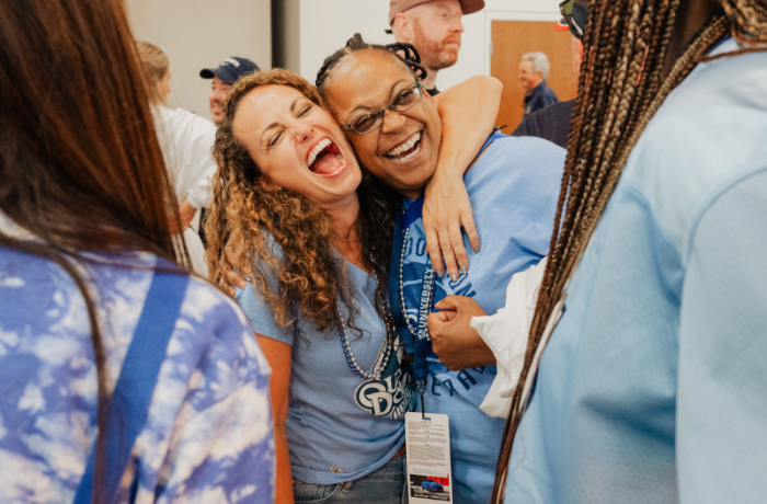 Two women hugging and laughing