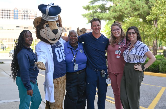 A group of people pose for a photo with Old Dominion University's mascot.