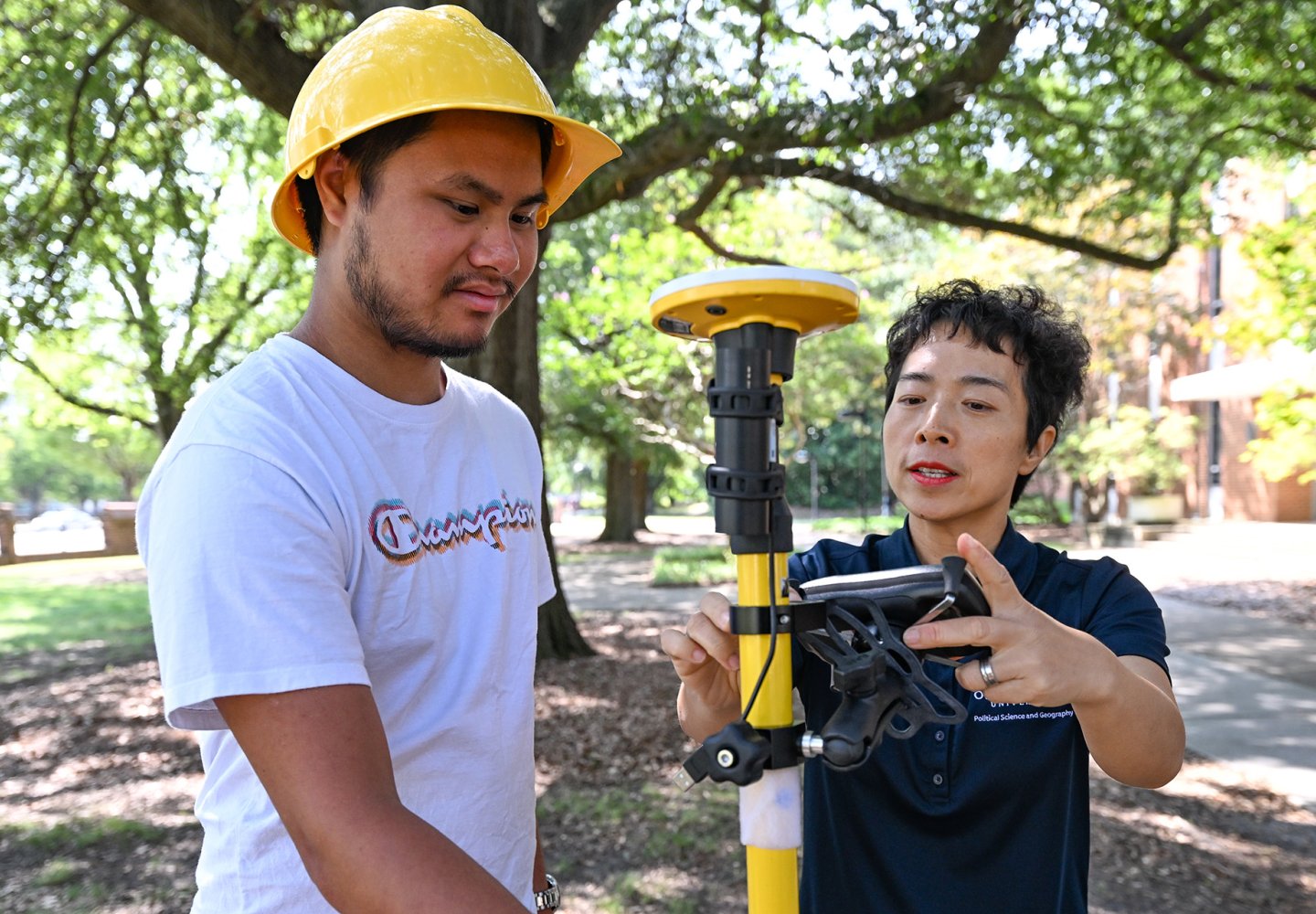 two people with measuring equipment