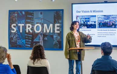 Female student gives group presentation.