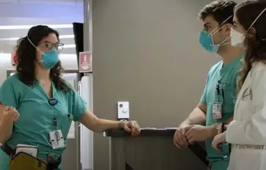 Anastasia Samaras, MD, a psychiatry resident, speaks to a ma