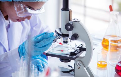 Woman using microscope
