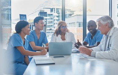 Doctors and administrators sitting around conference table