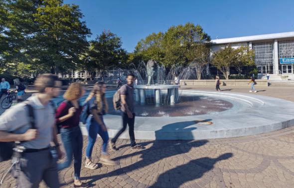 Students walking by Monarch fountain