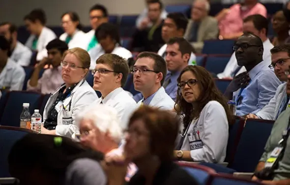 Students and faculty listen during Grand Rounds.