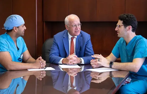 Lawrence B. Colen, MD, center, speaks two residents Jeremy J