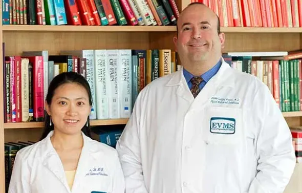 Dr. Antonio Quidgley-Nevares and a fellow pose in the librar