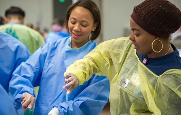 Surgical Assisting students practice sutures during Suture F