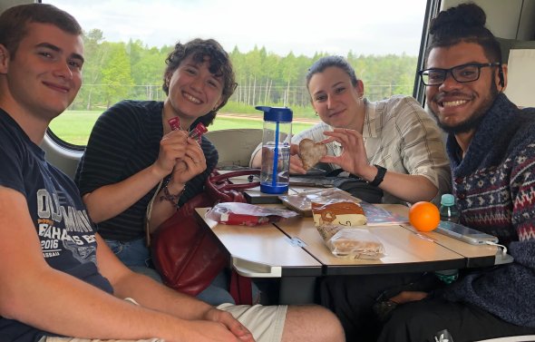 Group of four ODU students on sitting on train.
