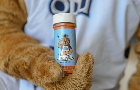 ODU’s mascot Big Blue holds a container of seasoning.