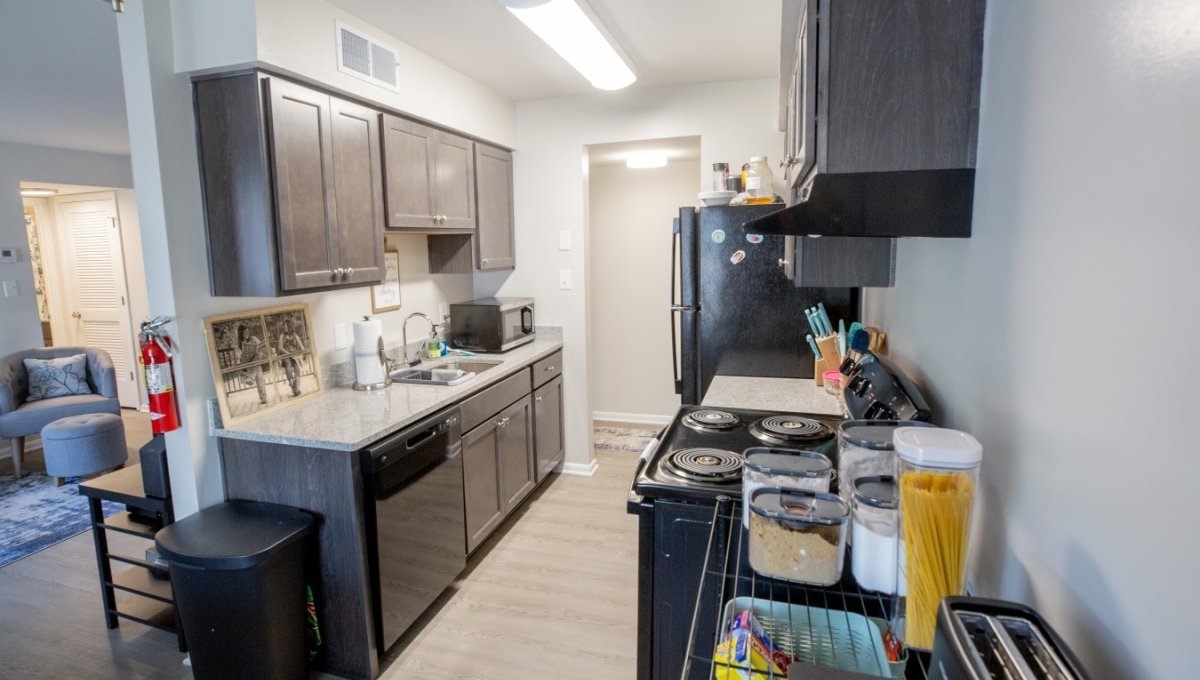 Kitchen with appliances, food, and wall decor.