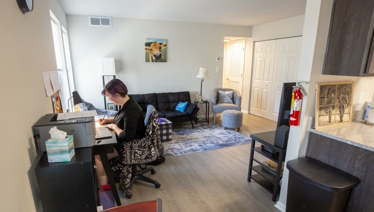 Student studying in living room.