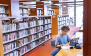 Student reading book in library