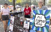 Students with signs at Student Organization Fair