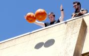 Corey Sargent demonstrates that when you drop two different-sized pumpkins, they smash at the same time.