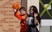 Daniel Akers retrieves a pumpkin that survived the nine-story fall, while Victoria Tabibi, master of ceremonies, narrates the event in 2019.