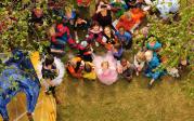 Students from the Children’s Learning & Research Center wear their Halloween costumes to watch the pumpkins fall.