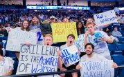 A group of fans sit in the stands at an ODU basketball game.