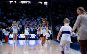 A group of cheerleaders perform during halftime at a basketball game. 