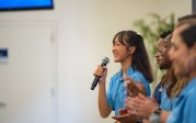 A woman speaks into a microphone.