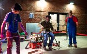 A group of people doing glassblowing.