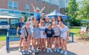 A group of students pose for a photo by an ODU bench.