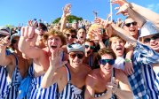 A group of students celebrate in the stands.