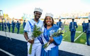 Two students pose for a photo in ODU's football stadium.