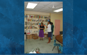 Women stocking shelves with books.
