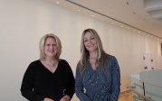 Two women pose for a photo inside ODU's Barry Art Museum.