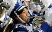 a young man holds a tuba 