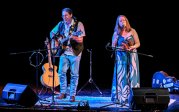 A man and woman perform on a stage.