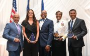 Five people pose for a photo at an alumni honors dinner. 