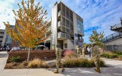 A person in military uniform walks by a building on ODU's campus.