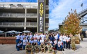 A group of high school students and Army ROTC cadets pose for a photo. 