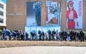 A group of people sticking shovels in the ground outside the Barry Art Museum.