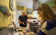 a man and a girl stand n a kitchen 