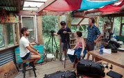 Group of students filming video of a person.