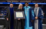 A group of people holding a degree