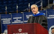 A photo of Bruce Bradley speaking at a podium.
