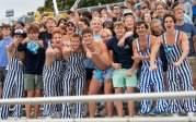 A group of students cheer from the stands at an ODU football game. 